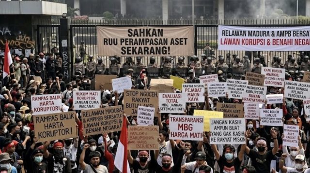 Massa aksi demo 27 Agustus berkumpul di depan Gedung DPR RI Senayan sambil membawa spanduk dan poster tuntutan pengesahan RUU Perampasan Aset.