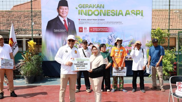 Cak Yebe bersama warga menunjukkan bantuan tanaman hias dalam kegiatan Gerakan Indonesia ASRI di Kampung Keputran, Surabaya.